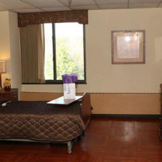 A cozy hotel room featuring a bed, bedside tables, and a window with curtains.