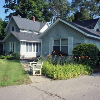 A suburban house with a well-maintained garden and driveway.