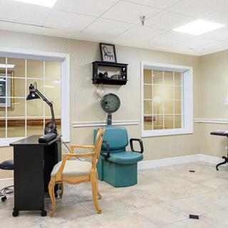 A bright office space with a desk, chairs, and windows.