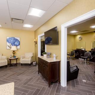Modern salon interior with a waiting area and comfortable seating.