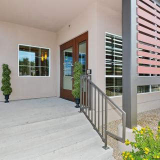 Modern house entrance with a porch and glass doors.