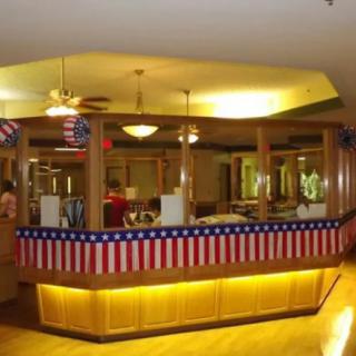 A restaurant counter decorated with patriotic bunting and flags.