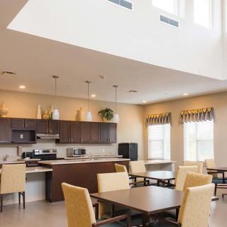 A modern kitchen and dining area with ample natural lighting and contemporary furniture.