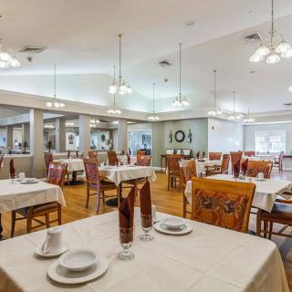 Elegant dining room with neatly set tables and ambient lighting.