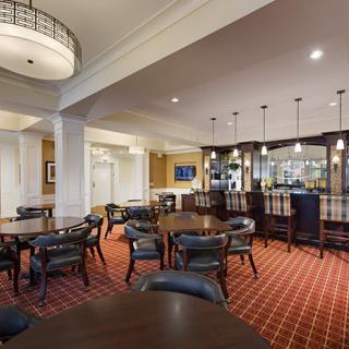 A stylish lounge area with a bar and seating arrangements.