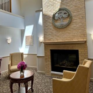 A cozy lobby area featuring a warm fireplace and comfortable seating.