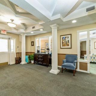 A well-lit lobby area with seating and decorative elements.