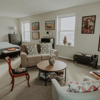 A cozy and modern living room with stylish furniture and art on the walls.