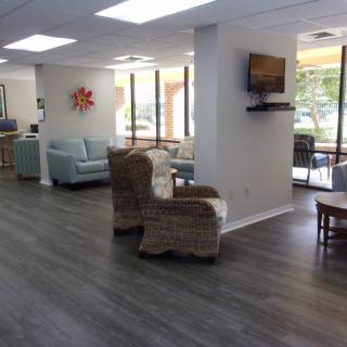 A modern, bright waiting room with comfortable seating and large windows.