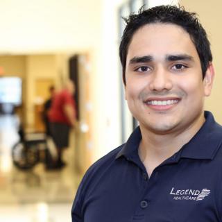 A smiling person in a professional setting.