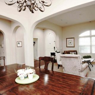 A spacious living and dining area with elegant furniture and decor.