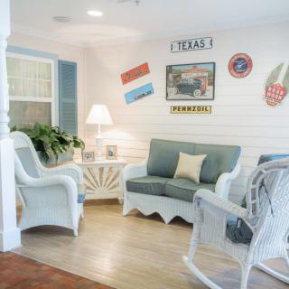 A cozy living room with coastal-themed decor and wicker furniture.