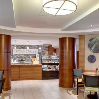 A modern cafe interior with wooden columns and a cozy seating area.