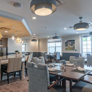 A modern dining room with stylish furniture and elegant lighting fixtures.