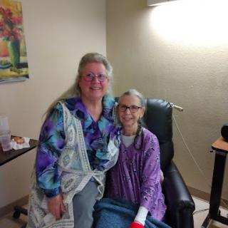 A heartfelt moment between a caregiver and her friend in a hospital setting.