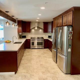 A modern kitchen with stainless steel appliances and wood cabinets.