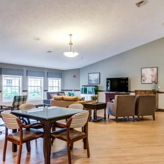 A modern open-concept living and dining area with stylish furniture and large windows.
