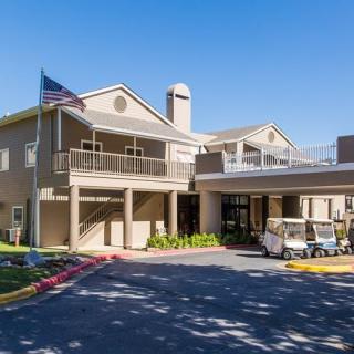 The exterior of a hotel building with an entrance area and a flag displayed outside.