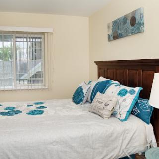 A cozy and well-decorated bedroom featuring blue and white accents.
