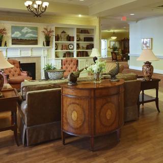 A cozy living room with elegant furniture and warm lighting.