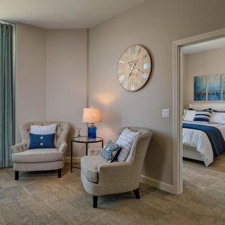 Cozy seating area adjacent to a bedroom with modern decor.