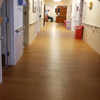A well-lit and clean hallway in a hospital.