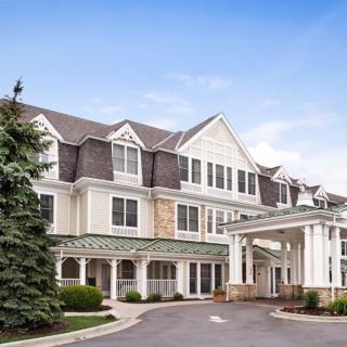 A view of a large hotel building with a grand entrance and well-maintained landscaping.