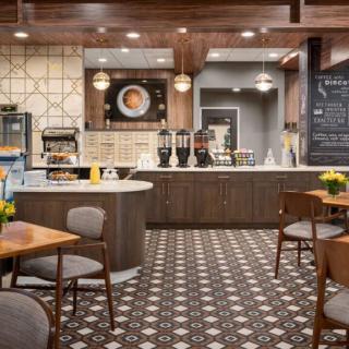 A modern cafe interior with stylish tiles, comfortable seating, and a well-organized counter.