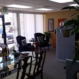 A bright and inviting office space featuring comfortable seating and a modern design.