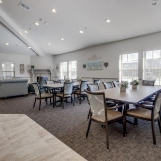 Spacious meeting room with modern furnishings and ample natural light.