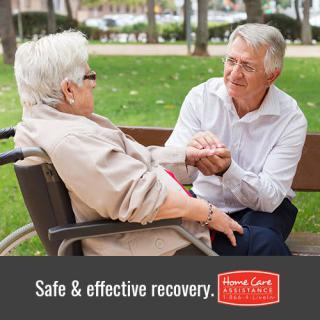 An elderly person in a wheelchair interacting with a caregiver in a park, promoting safe and effective recovery.