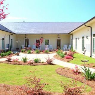 A well-maintained courtyard garden surrounded by a modern building.