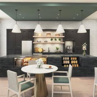A modern kitchen with sleek black cabinetry, white pendant lights, a central dining table, and contemporary appliances.