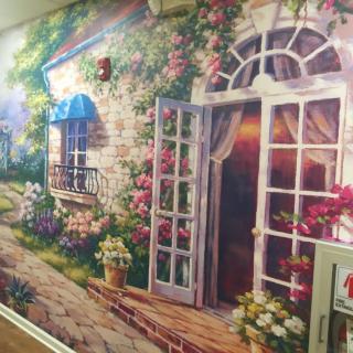 A vibrant mural depicting a charming cottage with abundant floral decorations and an open doorway.
