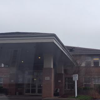 A view of the hospital entrance on a cloudy day.