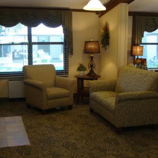 A cozy living room with comfortable seating and warm lighting.