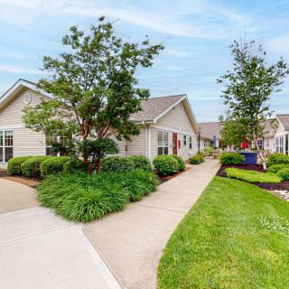 A well-maintained suburban neighborhood with lush greenery and clean pathways.