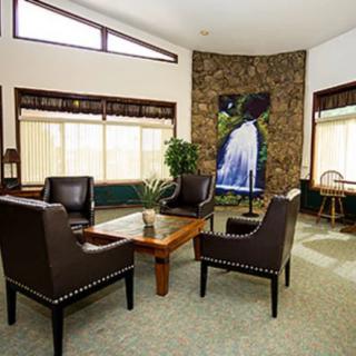 A modern living room interior with stylish furniture and a large piece of artwork on the wall.