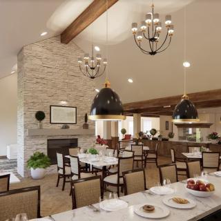 A beautifully designed dining area featuring modern decor with chandeliers and a stone fireplace.