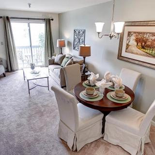 A cozy living room with a dining area, featuring elegant furniture and tasteful decor.