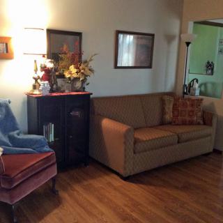 A cozy living room with a sofa, chair, and decorative elements.