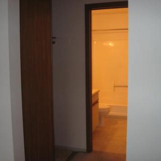A view through a doorway into a bathroom with warm lighting.