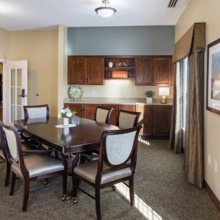 A well-appointed dining area with a wooden table, chairs, and cabinetry.
