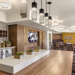A modern kitchen and dining area with stylish lighting and wooden accents.