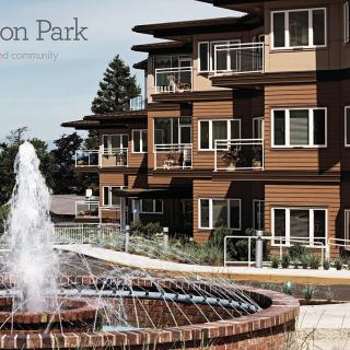 A modern apartment complex with a central fountain feature.