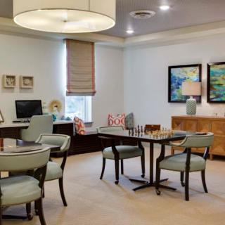 A modern and stylish office space featuring a comfortable seating area and elegant decor.