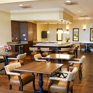 A cozy indoor dining area with wooden tables and comfortable seating.