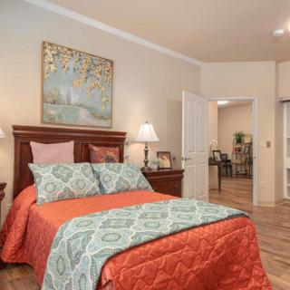 A cozy bedroom with elegant decor and vibrant bedding.