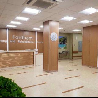 A modern reception area of a medical facility, featuring wooden finishes and a welcoming atmosphere.