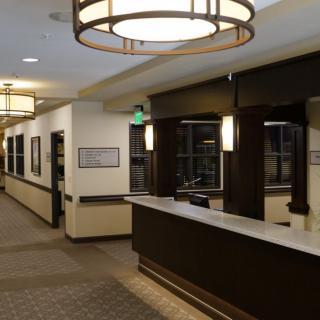 A modern office lobby with a reception desk and stylish lighting.